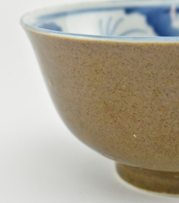 Lot 63 - TWO QING DYNASTY CERAMIC BOWLS 清 紫金釉酱釉青花碗和青釉碗