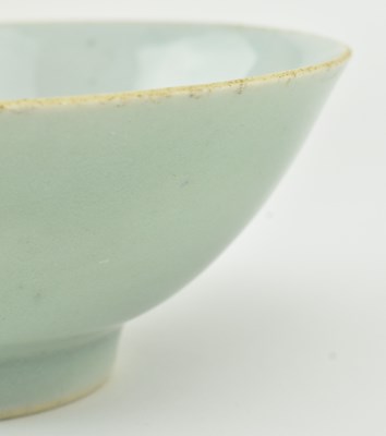 Lot 63 - TWO QING DYNASTY CERAMIC BOWLS 清 紫金釉酱釉青花碗和青釉碗