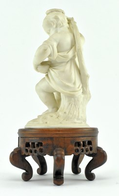 Lot 140 - 19TH CENTURY BISQUE FIGURINE CANDLE HOLDER RAISED ON WOODEN SOCLE BASE