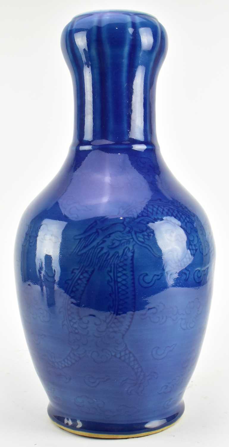 Lot 154 - QING / REPUBLIC MONCHROME BLUE GLAZED CERAMIC VASE 清 民国 刻龙纹蒜头瓶