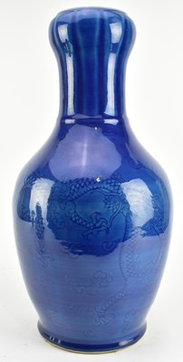 Lot 154 - QING / REPUBLIC MONCHROME BLUE GLAZED CERAMIC VASE 清 民国 刻龙纹蒜头瓶