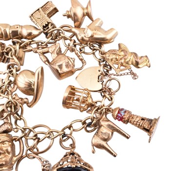 Lot 65 - HALLMARKED 9CT GOLD CHARM BRACELET WITH HEART PADLOCK CLASP