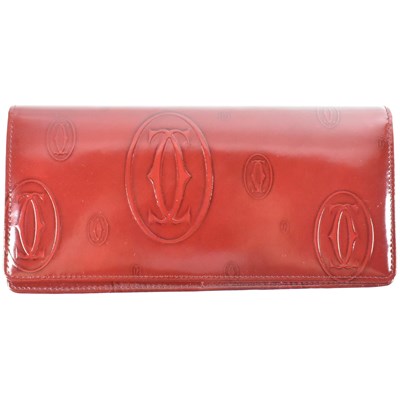 Lot 537 - CARTIER BURGUNDY PATENT LEATHER LOGO WALLET