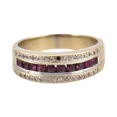 Lot 212 - An 18ct gold ruby and diamond band ring. The...