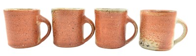 Lot 28 - LISA HAMMOND FOR MAZE HILL POTTERY - FOUR STUDIO POTTERY STONEWARE MUGS, SODA SHINO GLAZE