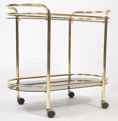 Lot 586 - VINTAGE 1960S ITALIAN STYLE BRASS AND SMOKED GLASS TEA TROLLEY