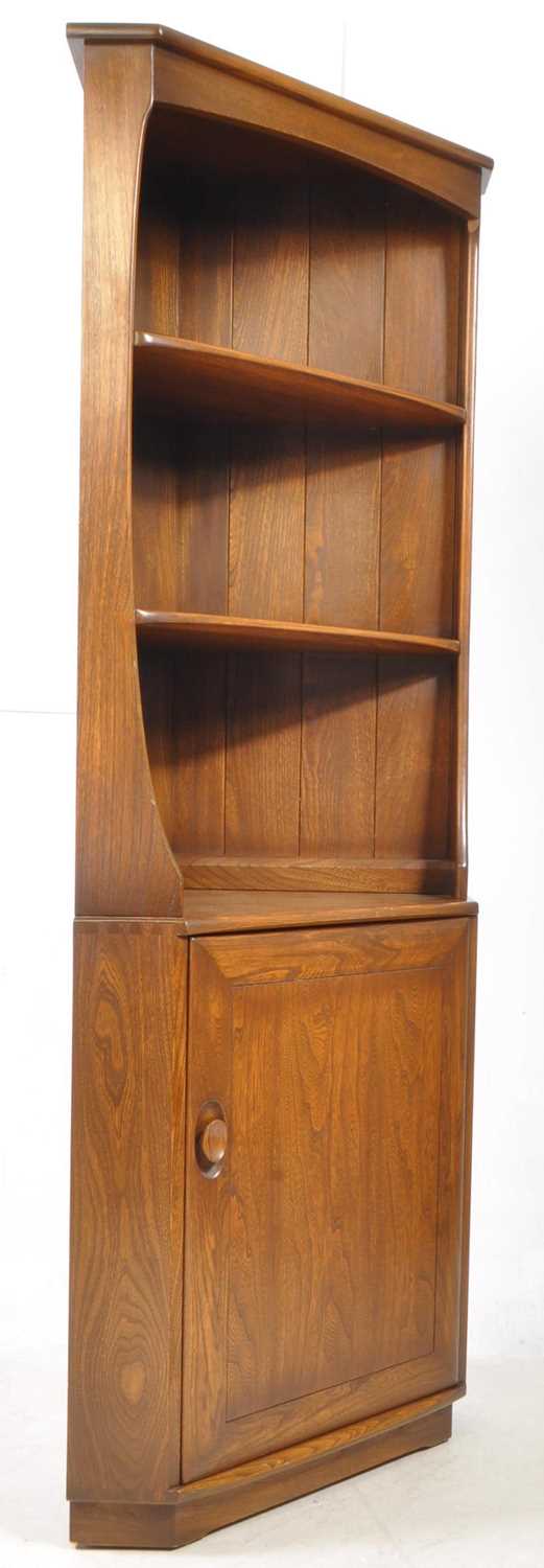 Lot 802 - ERCOL FURNITURE - 20TH CENTURY BEECH & ELM WOOD CORNER CUPBOARD