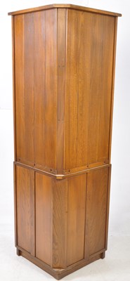 Lot 802 - ERCOL FURNITURE - 20TH CENTURY BEECH & ELM WOOD CORNER CUPBOARD