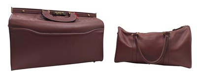Lot 50 - LES MUST DE CARTIER - TWO VINTAGE MAROON LEATHER TRAVEL BAGS