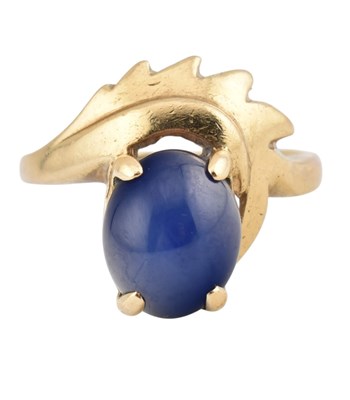 Lot 206 - A 10k and star sapphire dress ring. The ring...