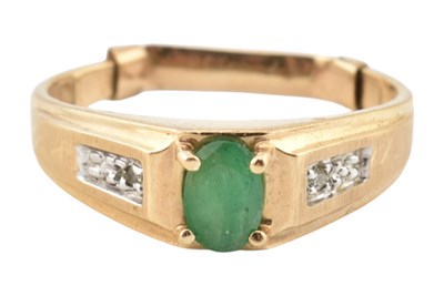 Lot 215 - A 10k gold emerald and diamond ring. The ring...