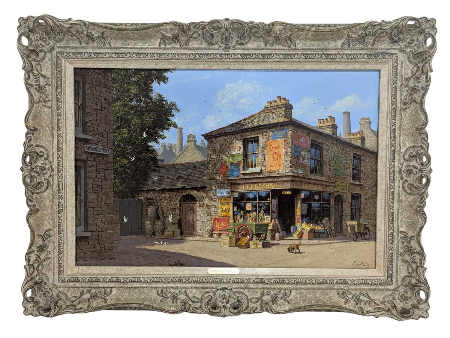 Lot 250 - EDWARD HERSEY (B. 1948) - OIL ON CANVAS STREET SCENE WITH ENAMEL SIGNS