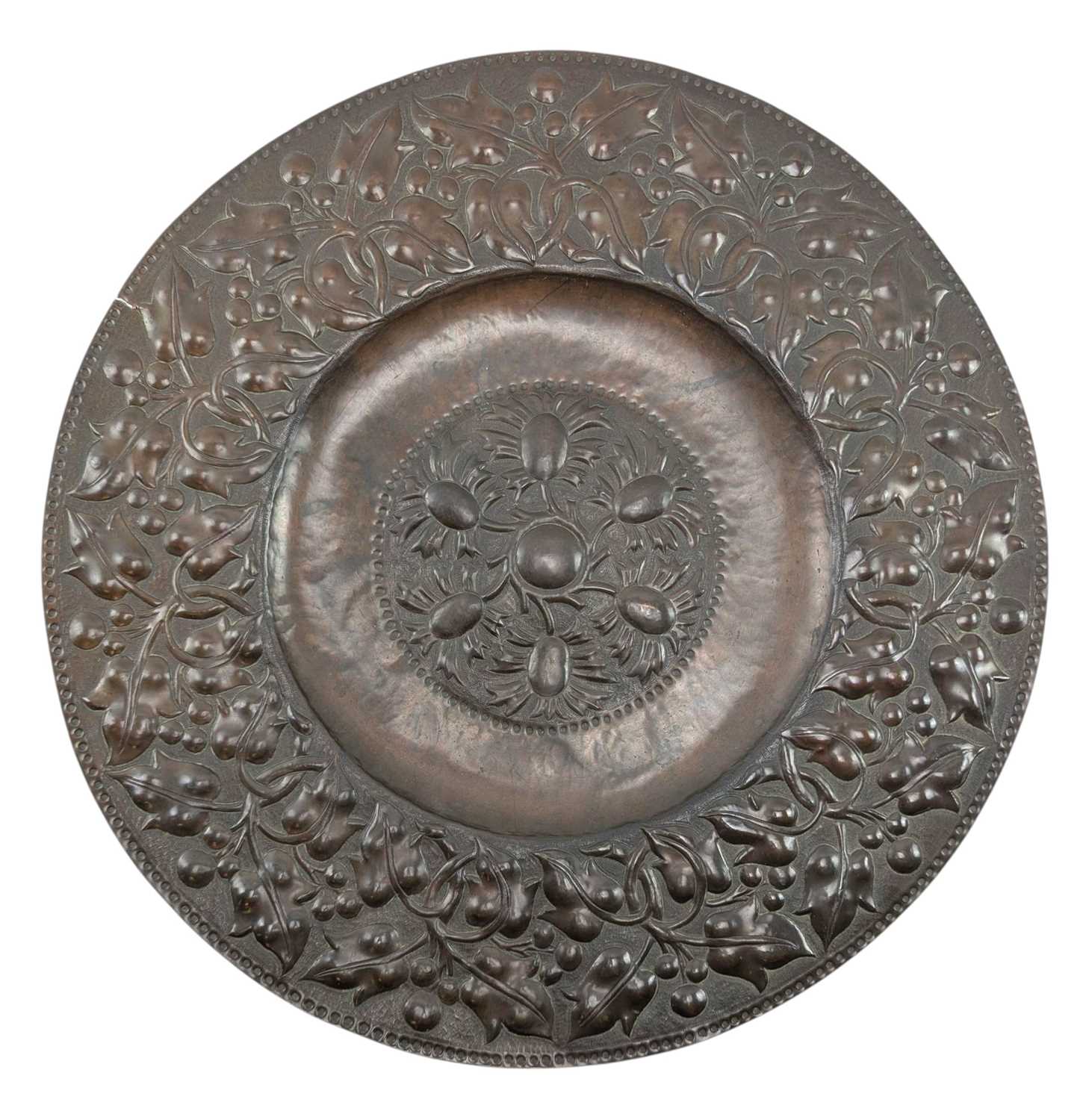 Lot 130 - BELIEVED JOHN PEARSON, NEWLYN SCHOOL, REPOUSSE COPPER FLORAL CHARGER