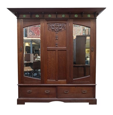 Lot 620 - MANNER OF SHAPLAND & PETTER - ARTS & CRAFTS CIRCA 1920S OAK TRIPLE WARDROBE