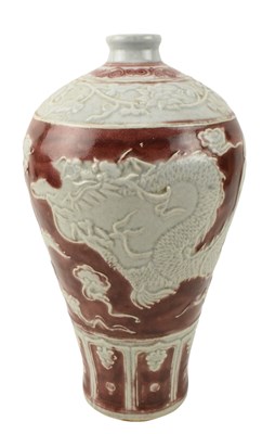 Lot 87 - UNDERGLAZED COPPER RED CARVED 'DRAGON' MEIPING VASE 釉里红刻龙纹梅瓶