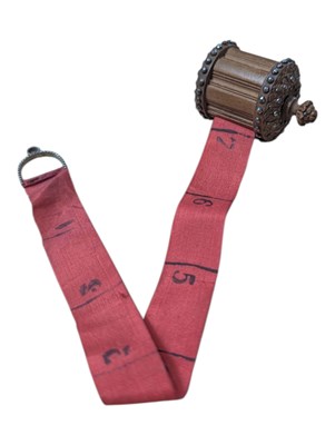 Lot 357 - 20TH CENTURY TIBETAN CARVED WOODEN AND FABRIC MEASURING TAPE