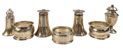 Lot 144 - TWO SETS OF HALLMARKED SILVER SALT & PEPPER SHAKERS & NAPKIN RINGS
