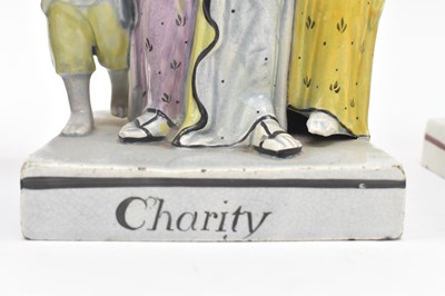 Lot 108 - THREE EARLY 19TH CENTURY STAFFORDSHIRE FIGURINES OF ELIJAH & CHARITY
