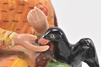 Lot 108 - THREE EARLY 19TH CENTURY STAFFORDSHIRE FIGURINES OF ELIJAH & CHARITY