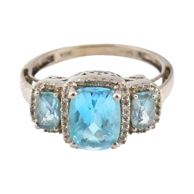 Lot 283 - 10K GOLD TOAPZ & DIAMOND THREE STONE HALO RING