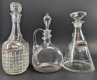 Lot 49 - THREE VICTORIAN 19TH CENTURY & LATER GLASS DECANTERS BOTTLES WITH SILVER LABELS