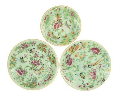 Lot 73 - THREE CHINESE QING DYNASTY CELADEON GROUND CANTON FAMILLE ROSE CHARGER PLATES