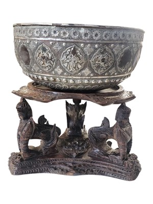 Lot 328 - 19TH CENTURY BURMESE SILVER PLATED THABEIK BOWL ON A CARVED WOODEN STAND
