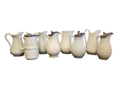 Lot 140 - EIGHT 19TH CENTURY VICTORIAN CERAMIC RELIEF MOULDED PARIAN WARE WHITE JUGS