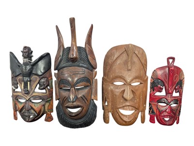 Lot 361 - TRIBAL ART - FOUR 20TH CENTURY CARVED HARDWOOD AFRICAN MASKS