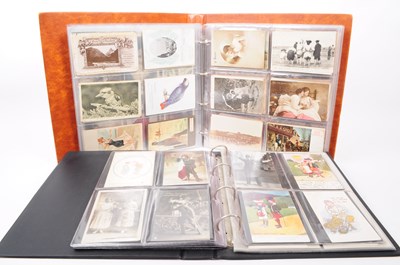 Lot 521 - TWO ALBUMS OF UNSORTED 19TH CENTURY & LATER POSTCARDS