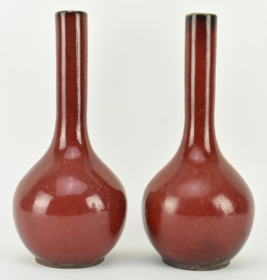 Lot 40 - PAIR OF QING DYNASTY FLAMBE SANG DE BOEUF BOTTLE VASES 清 窑变釉长颈瓶一对