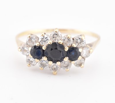 Lot 214 - HALLMARKED 18CT GOLD SAPPHIRE & WHITE STONE CLUSTER RING