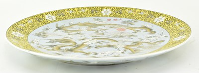 Lot 64 - QING DYNASTY POLYCHROME ENAMELLED PLATE 清 珐琅彩花穿龙纹盘
