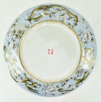 Lot 64 - QING DYNASTY POLYCHROME ENAMELLED PLATE 清 珐琅彩花穿龙纹盘