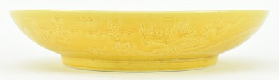 Lot 130 - HONGZHI MARKED INCISED YELLOW GLAZED DRAGON CHARGER 大明弘治款黄地暗花龙纹盘