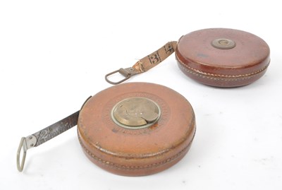 Lot 238 - SET OF TWO 1960S LEATHER CASED SURVEYOR TAPE MEASURES