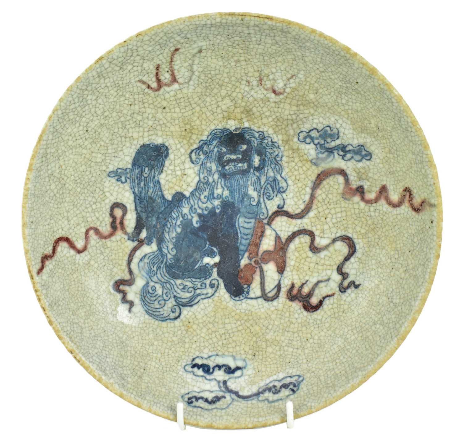 Lot 58 - QING GE-TYPE BLUE AND WHITE UNDERGLAZE RED CHARGER 清 哥窑青花釉里红狮子滚绣球盘