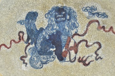 Lot 58 - QING GE-TYPE BLUE AND WHITE UNDERGLAZE RED CHARGER 清 哥窑青花釉里红狮子滚绣球盘