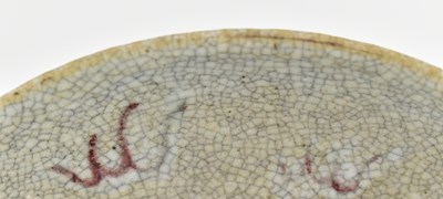 Lot 58 - QING GE-TYPE BLUE AND WHITE UNDERGLAZE RED CHARGER 清 哥窑青花釉里红狮子滚绣球盘