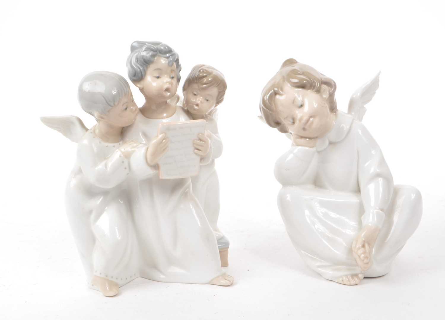 Lot 65 - LLADRO - TWO HAND MADE SPANISH PORCELAIN CHERUB FIGURINES